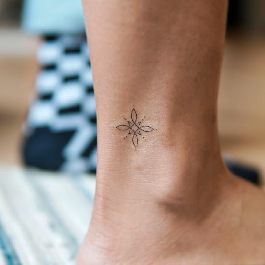 Flower and star ankle tattoo