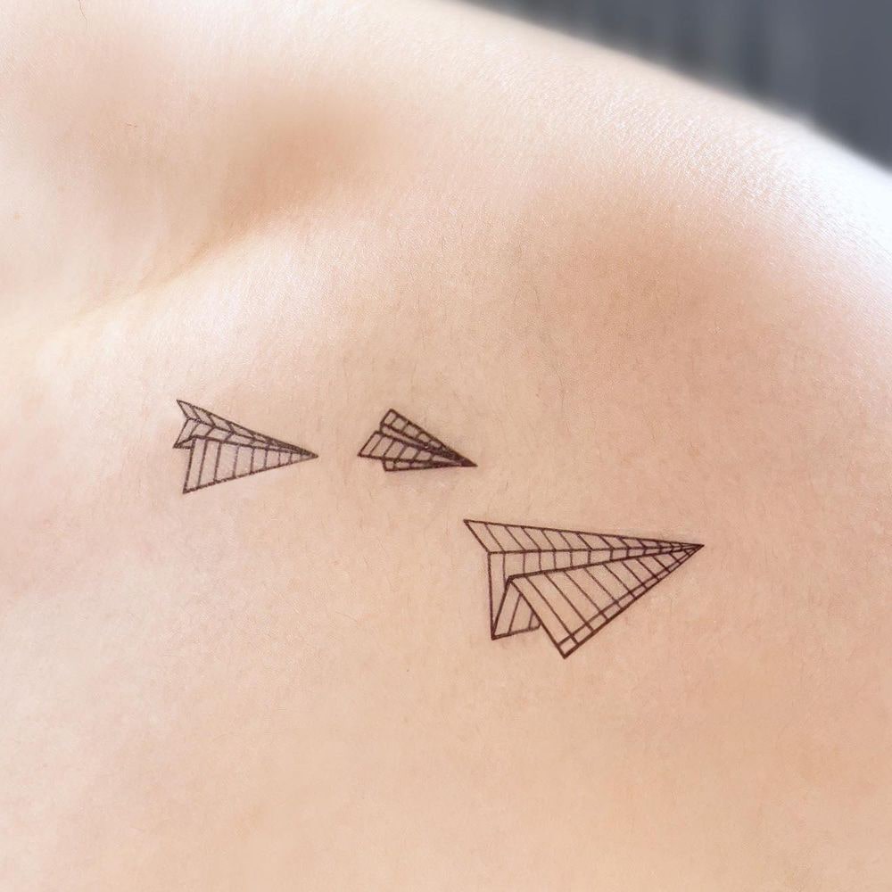 Paper airplane line tattoo