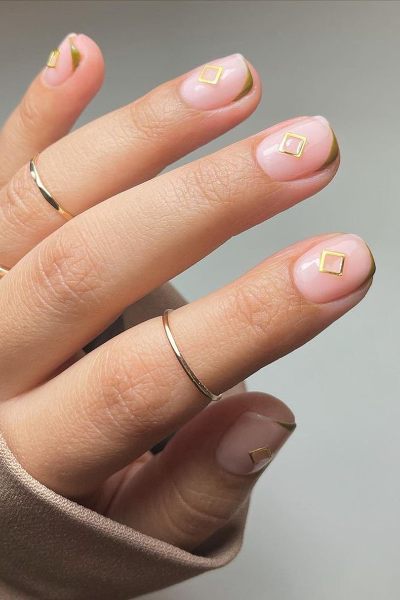 Gold hardware negative space nails