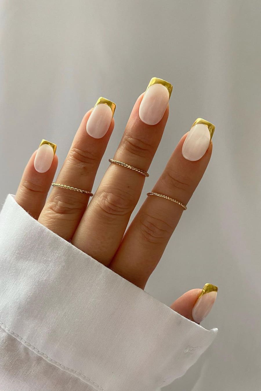 French chrome nails with golden tips