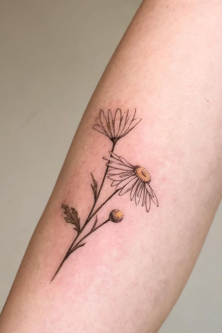 Daisy small colorful tattoo