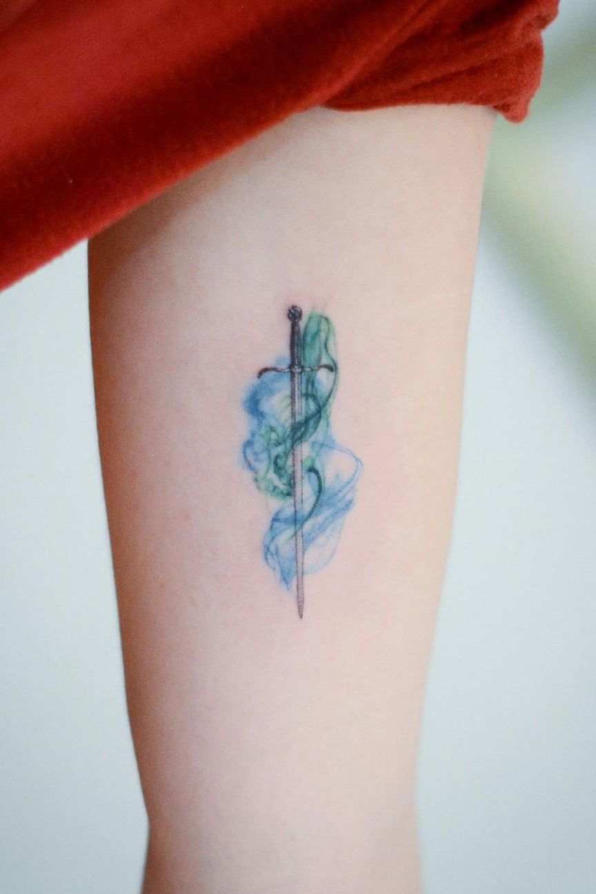 Sword small colorful tattoo