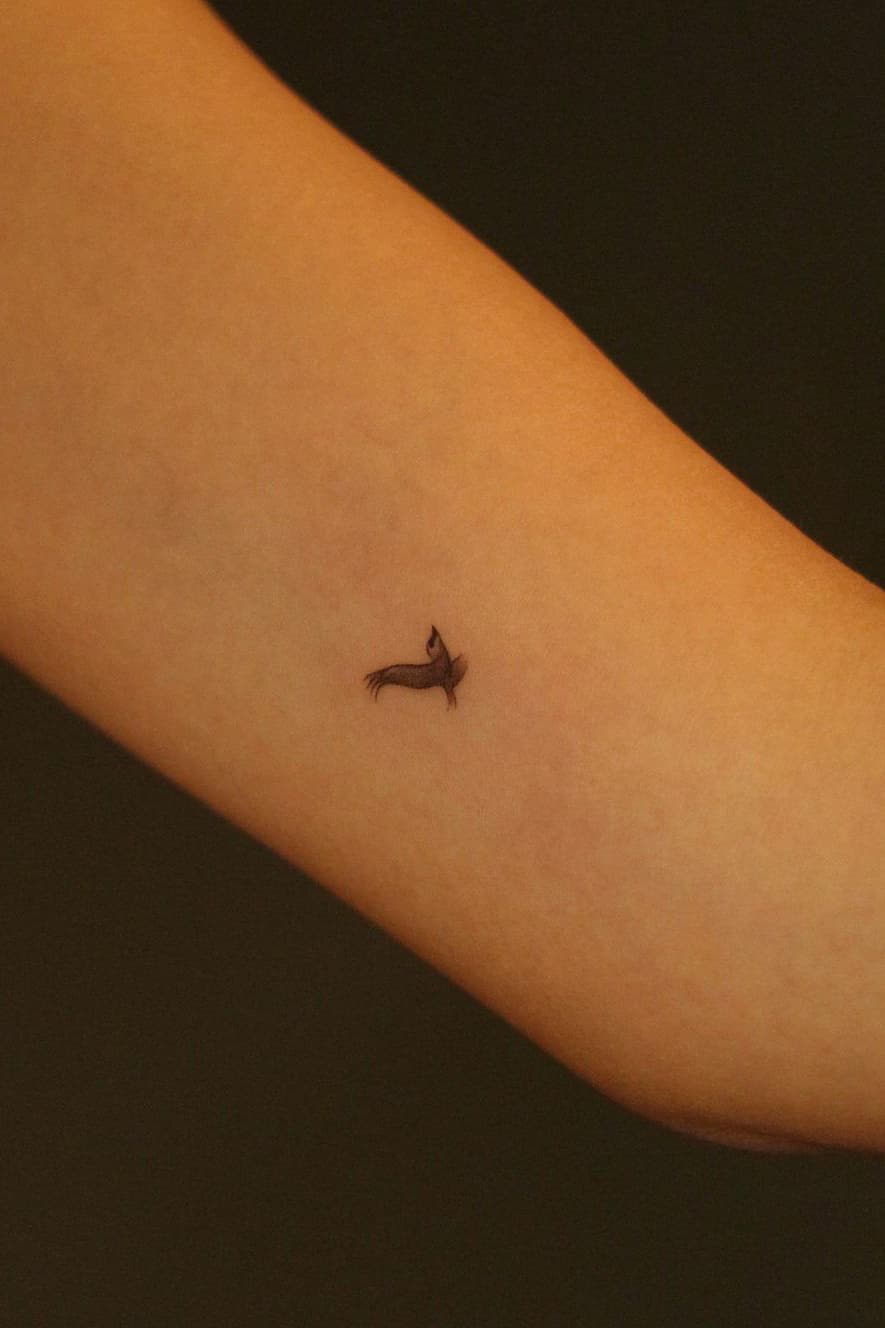 Realistic tiny bird tattoo