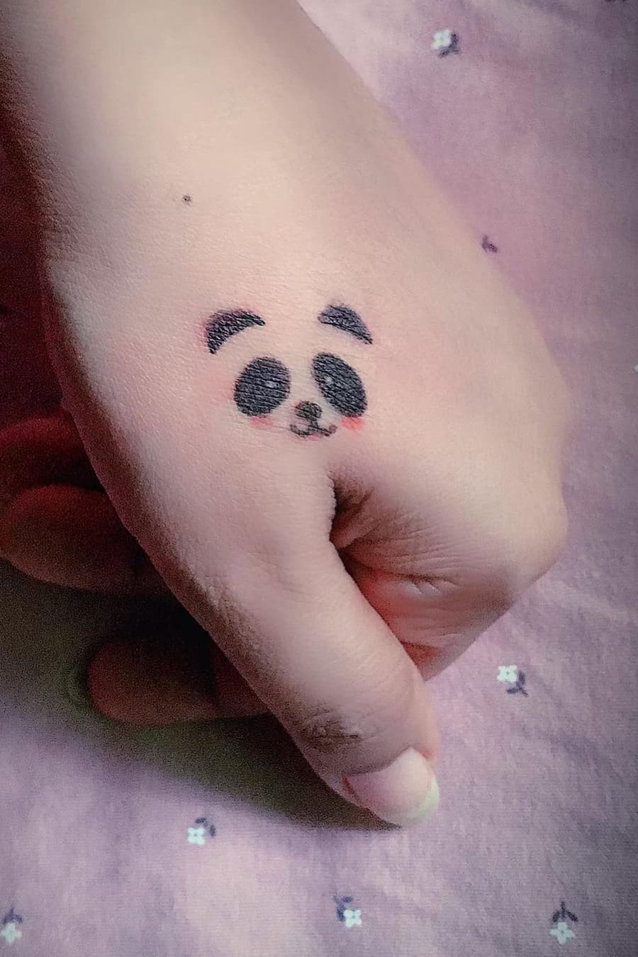 Panda tattoo on hand