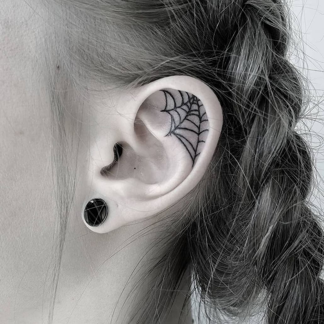 Spider web tattoo on the ear