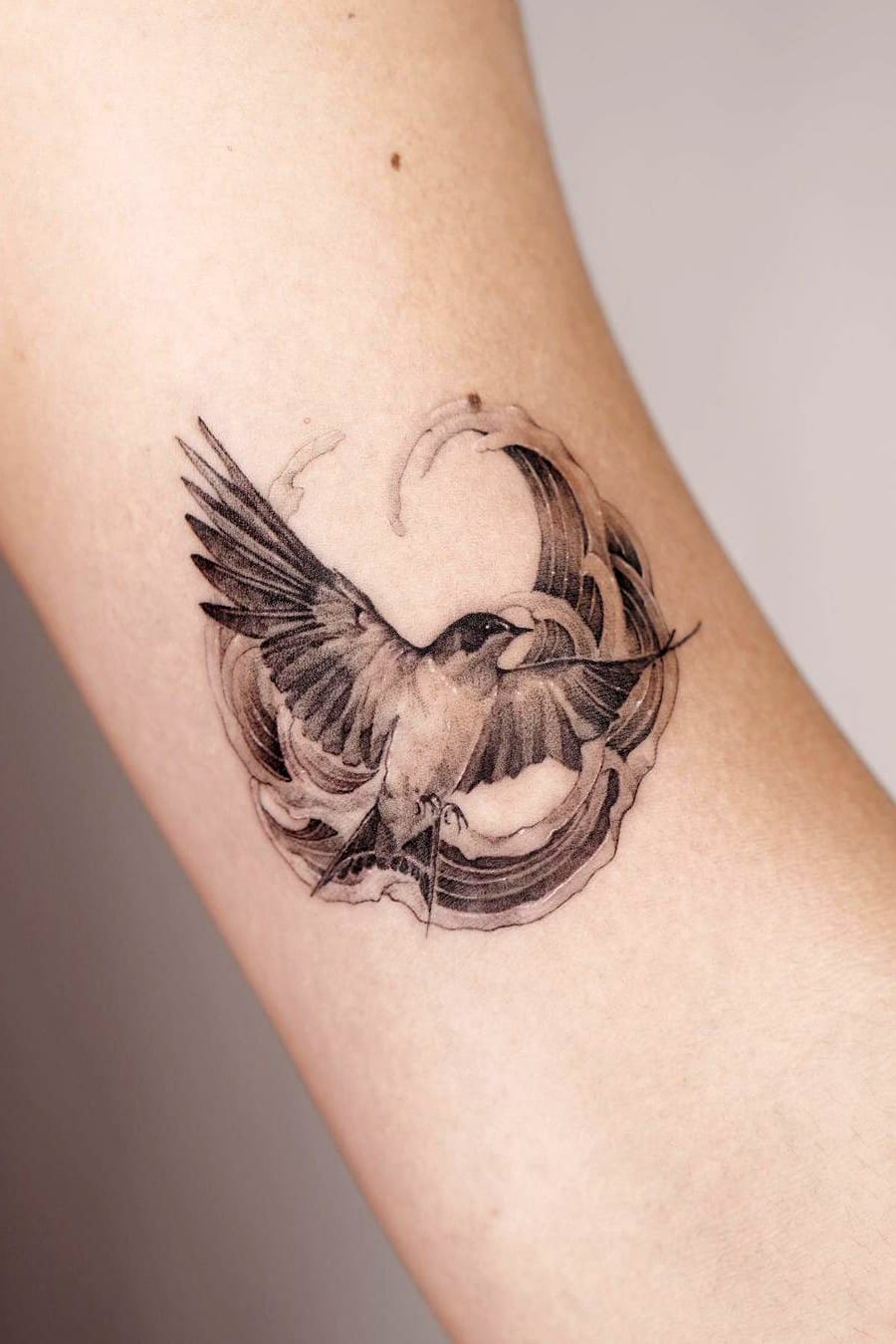 Bird and wave tattoo