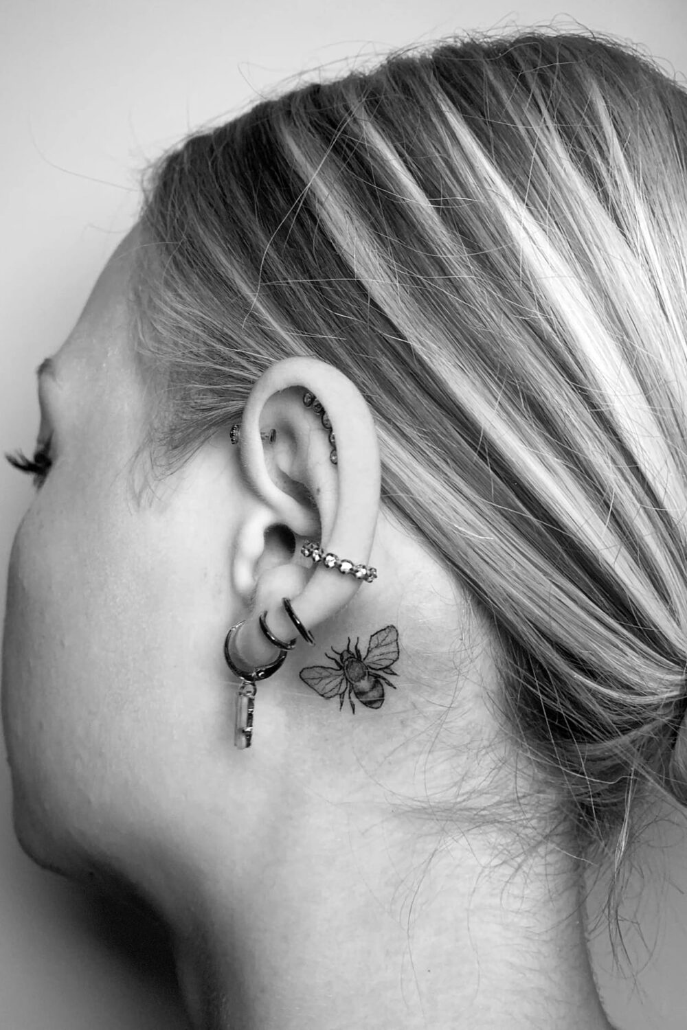 Bee tattoo behind ear-1