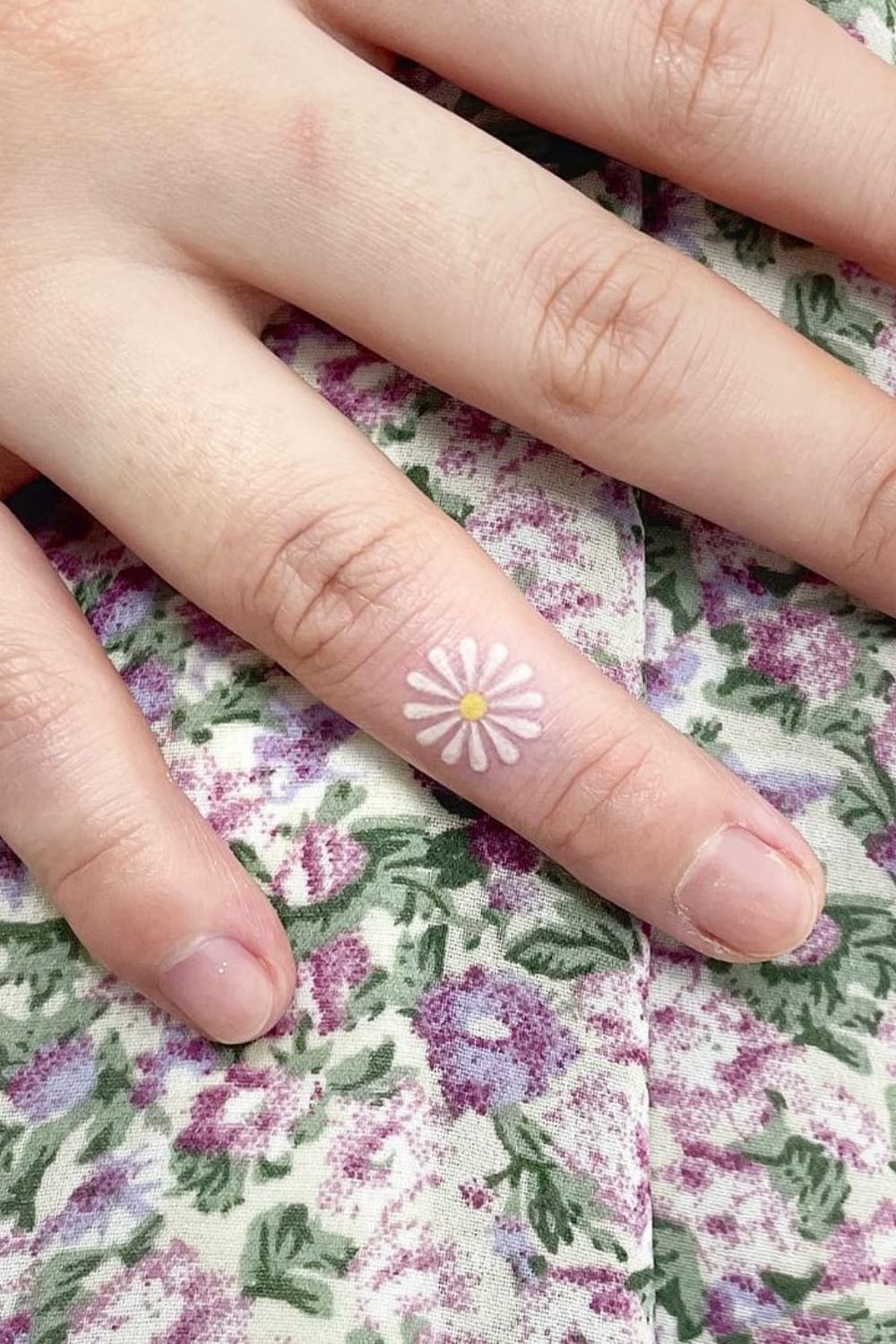 Daisy finger tattoo