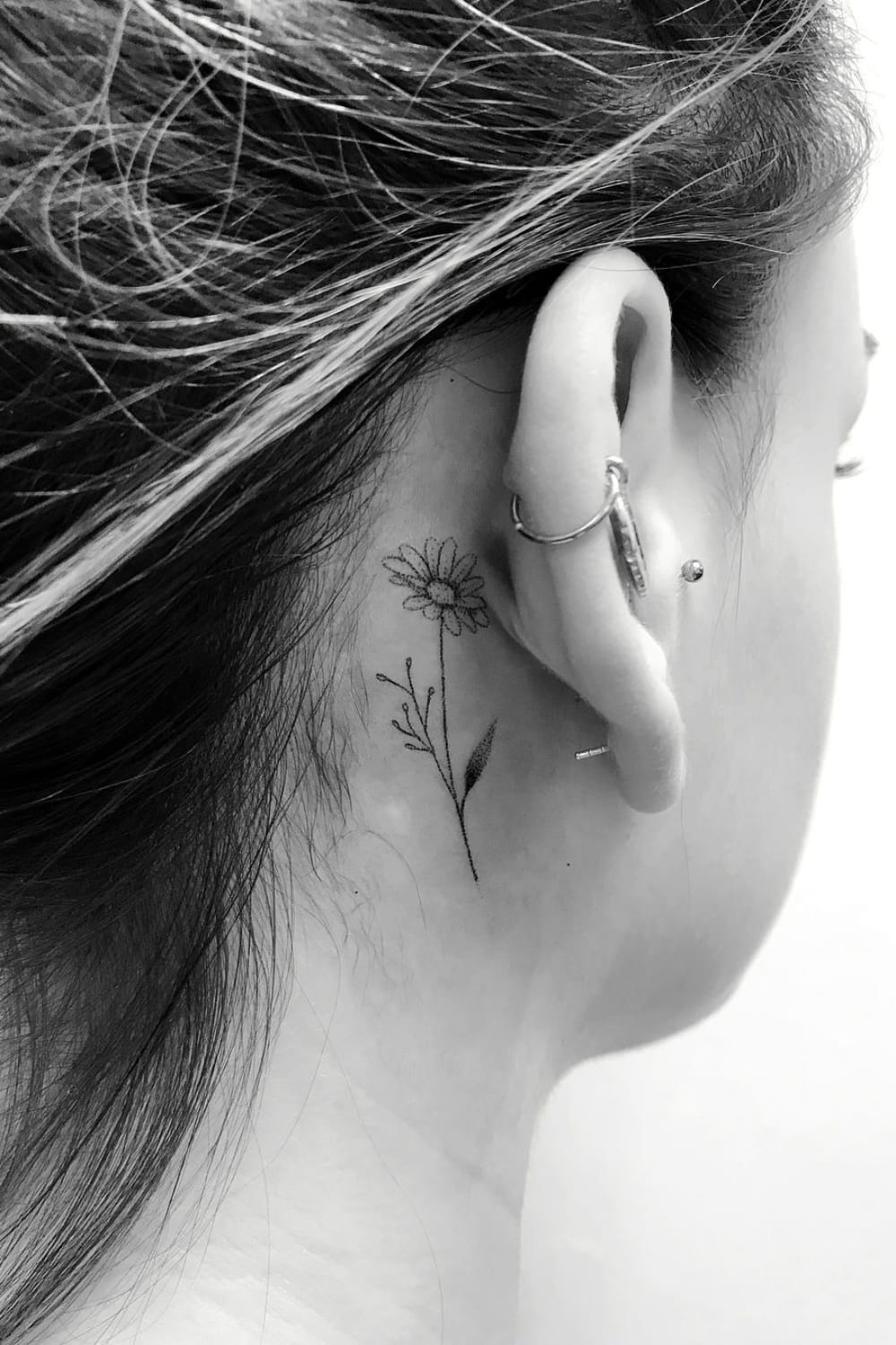 Daisy tattoo behind ear