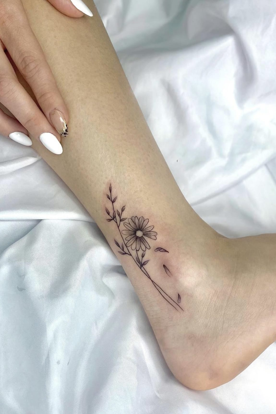 Daisy tattoo on ankle