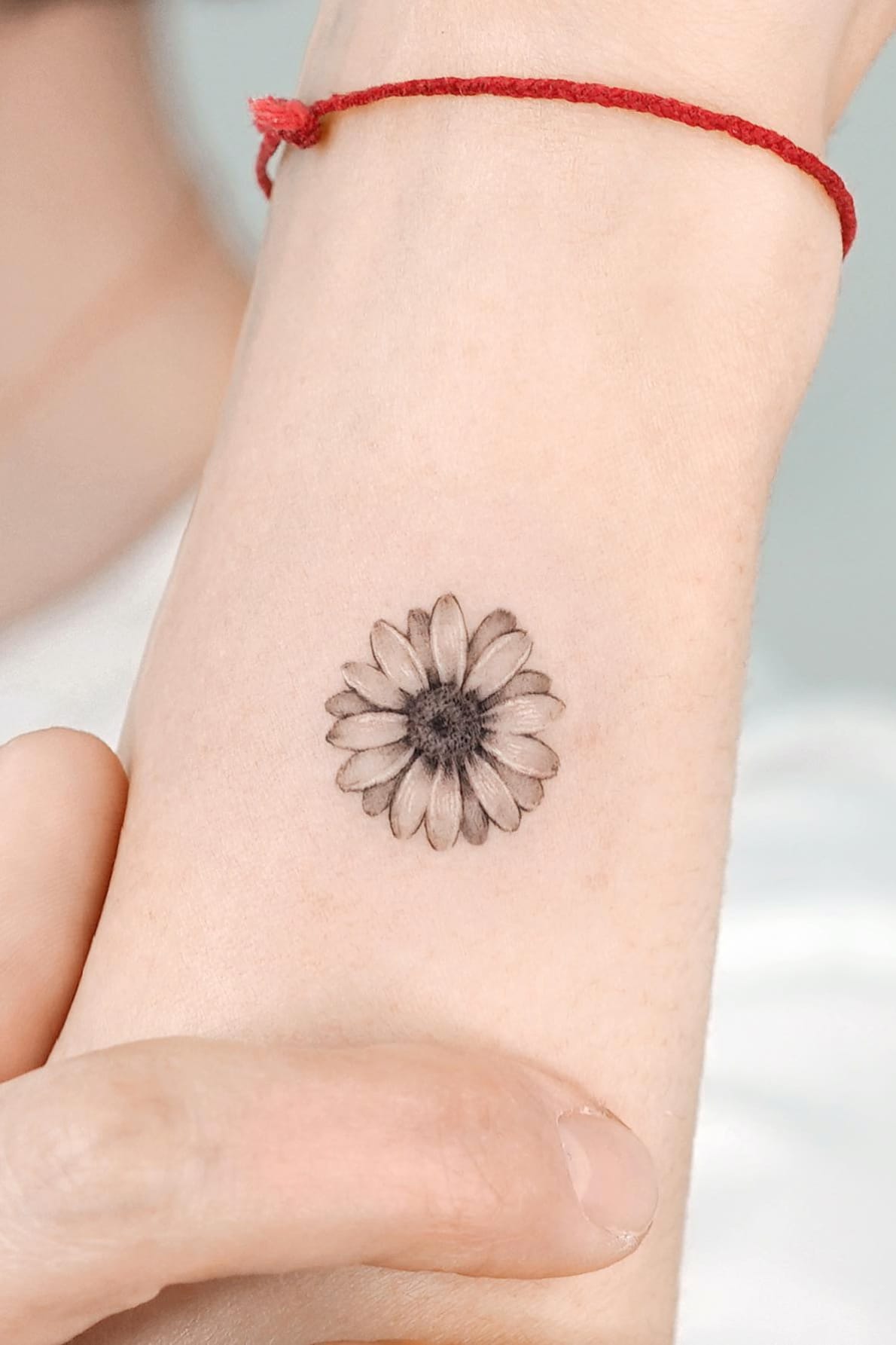 black and white daisy tattoo