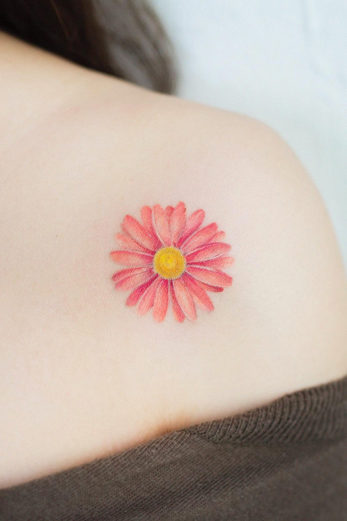 pink daisy tattoo