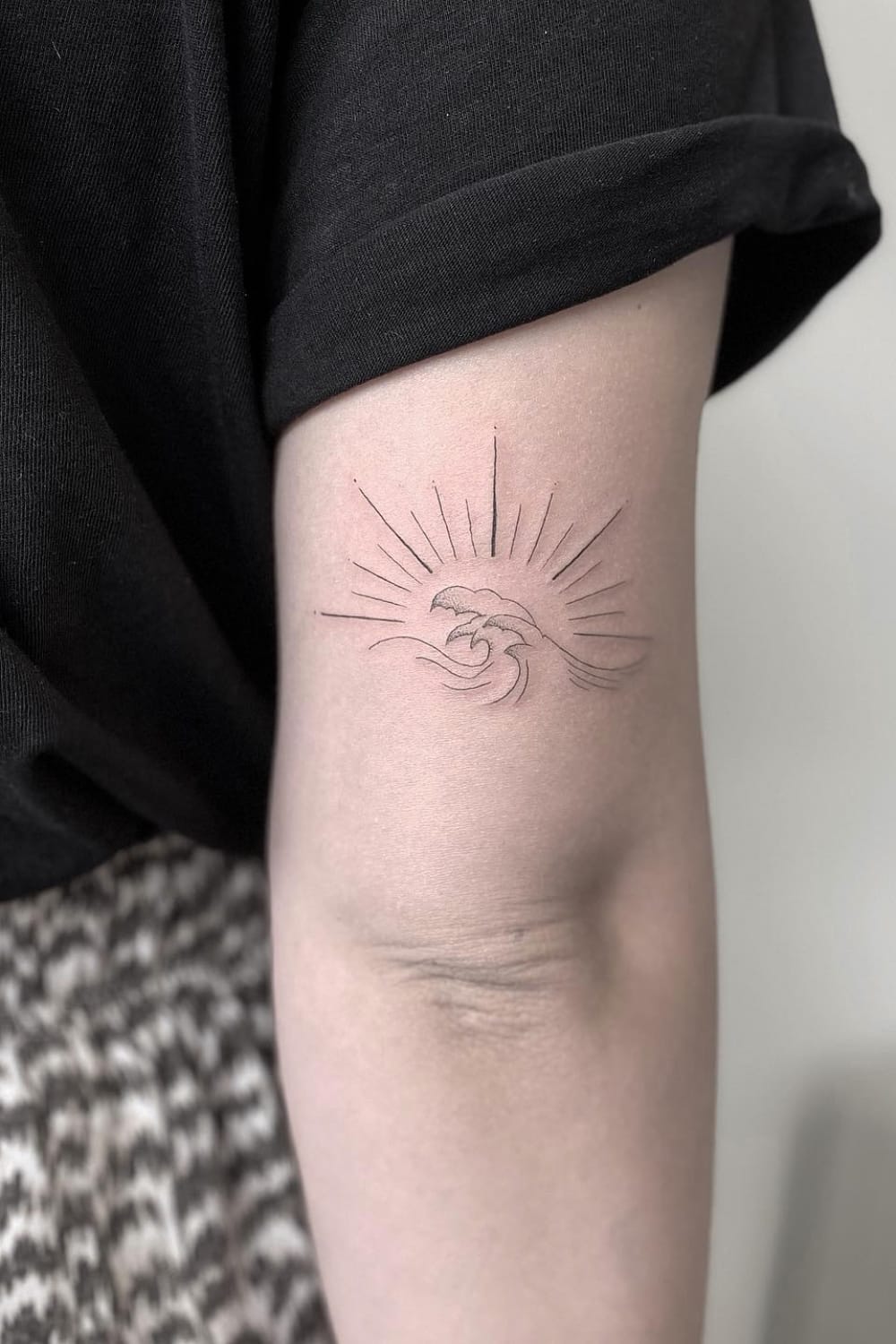 Wave and sun tattoo