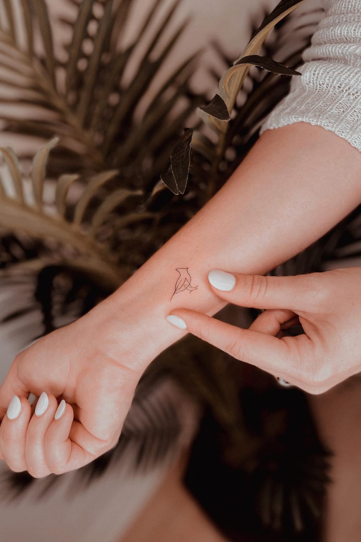 Small cardinal tattoo on wrist