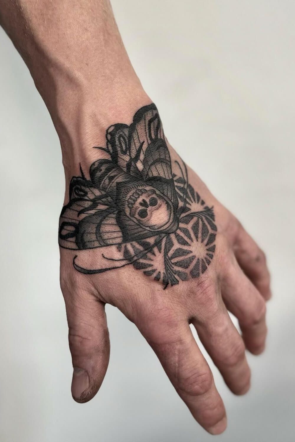 Moth Hand Tattoo