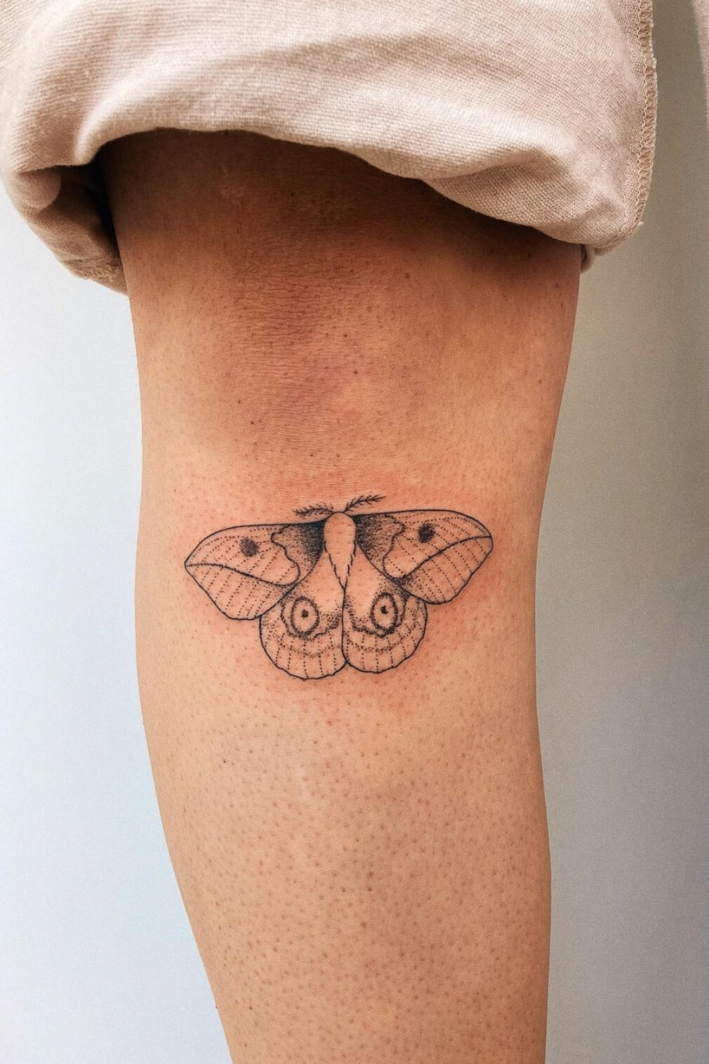 Small moth tattoo